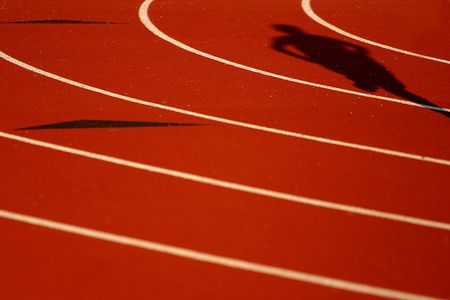 Shadow of a runner, focus is on the shadow and upper half of pictureの写真素材