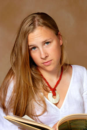 A teen looks up in disgust at being interupted from her reading