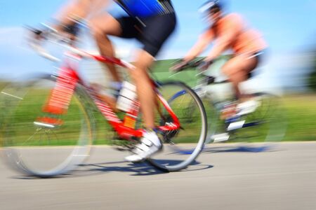 Two bicyclists in a race through the countryside 