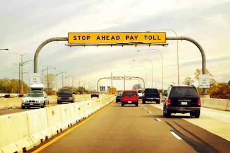 Cars on the highway leading in and out of a toll booth