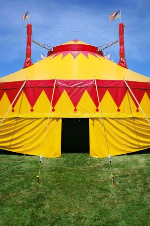 a close-up of a circus tent  on bright green grass and a blue skyの写真素材