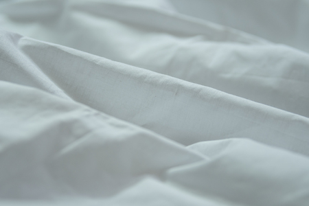 A simple isolated white cloth background with natural curves in a white clothの写真素材
