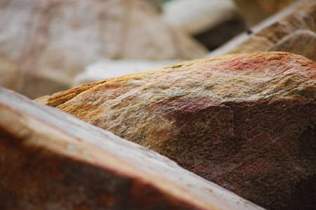 Rocks, left right and center - with orage, maroon and white shadesの写真素材