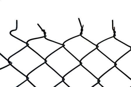 The top of a cut wire fence. The move from the consistent patterned shapes at the bottom, to twisted, skewed, cut shapes at the top.の写真素材