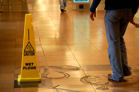 Caution Wet Floor sign in a shopping mallの写真素材