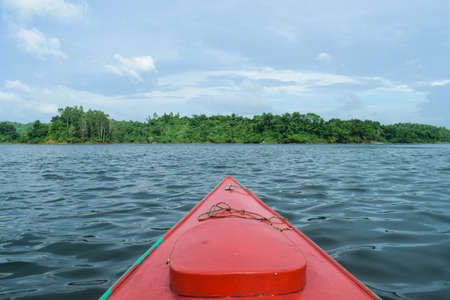 Kayaking in the lake surrounded by mountainの写真素材