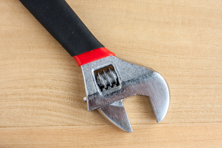 Adjustable Wrench on a wooden work bench 