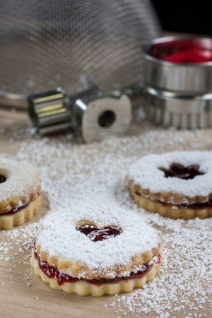 Raspberry Linzer cookies on a wooden work bench.の写真素材