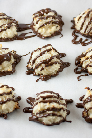 Homemade coconut Macarons with chocolate drizzled over the top.の写真素材