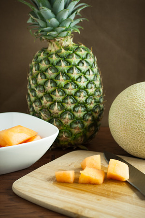 Cantalope and pinapple on a counter in the morning sun.の写真素材