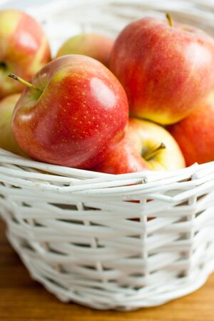 Fresh Gala Apples in a white wicker basket.の写真素材