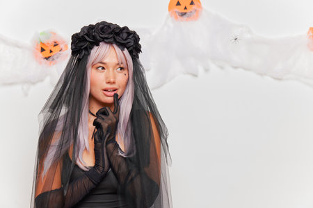 Beautiful asian woman wearing black gothic costume for halloweenの写真素材