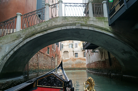 Gondola trip on a canal in Veneziaの写真素材
