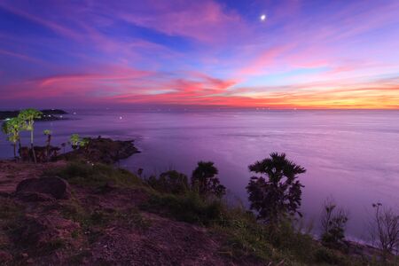 Beautiful sunset in promthep cape is a mountain of rock that extends into the sea in Phuket, Thailandの写真素材