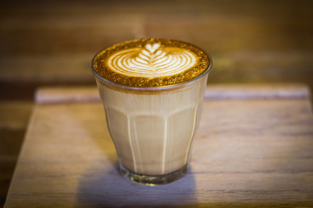 coffee latte art on the wood desk at coffee shopの写真素材