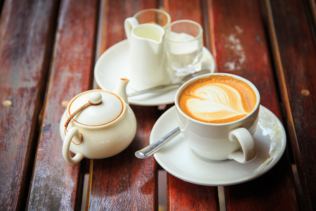 coffee latte art on the wood desk at coffee shopの写真素材