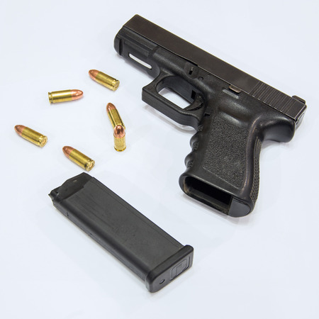 Closeup Bullets and Gun on white background