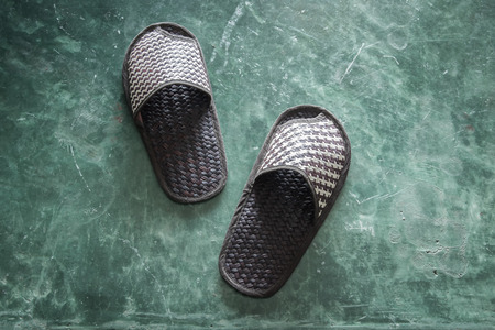Pair of brown shoes for in room on cement floor in bed room