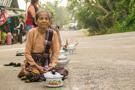 Sangkla Buri , Kanchanaburi, THAILAND - OCT 26 : Buddhist monks are given food offering from people...