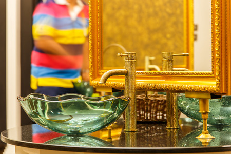 Water drop from gold colour faucet.の写真素材