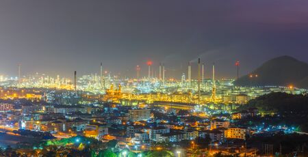 Oil refinery with tube and oil tank along night sky at Si Racha District, Rayong Province, Thailand
