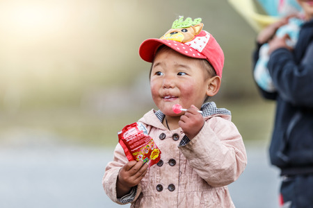 Danba, China - May 2016 - China lineage Tibet kids from the villages around Danba enjoying a piece...