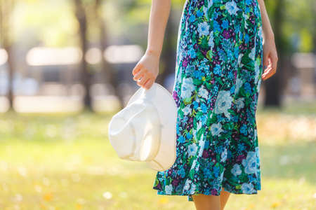Close Up hand young asian female holding a white hatの写真素材