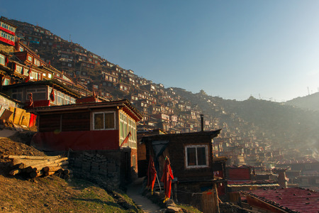 Top view monastery at Larung gar (Buddhist Academy) in a warm and foggy morning time, Sichuan, Chinaの写真素材