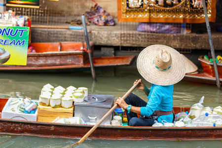 Local vendors selling goods at Damnoen Saduak Floating Market near Bangkok in Thailand, Damnoen Saduak is a very popular tourist attraction.の写真素材