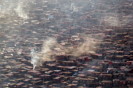 Top view monastery at Larung gar (Buddhist Academy) in a warm and foggy morning time, Sichuan, Chinaの写真素材
