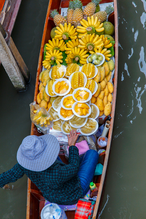 Long-tail boat with fruits on the floating market, Ha long bay, Vietnamの写真素材