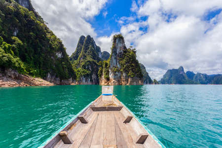 Traditional longtail boat with beautiful scenery view in Ratchaprapha Dam at Khao Sok National Park,...