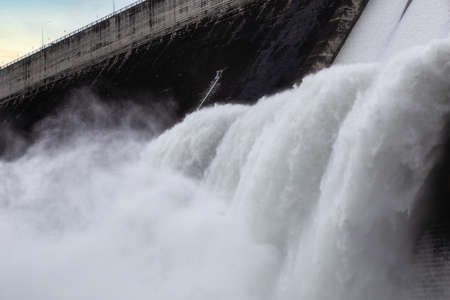 Water flowing over floodgates of a dam at Khun Dan Prakan Chon, Nakhon Nayok Province, Thailandの写真素材