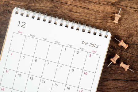 Top view Calendar desk 2022 on December month, The concept of planning and deadline with push pin on wooden table background. Business planning appointment meeting conceptの写真素材