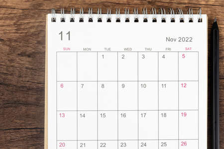 Top view calendar desk 2022, Calendar planning in November month and pencil on wooden table...