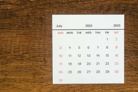 Top views Calendar desk July is the month for organizers to plan and remind on the wooden table...