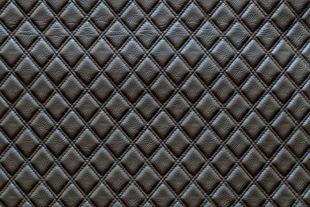 Black leather and a textured background.