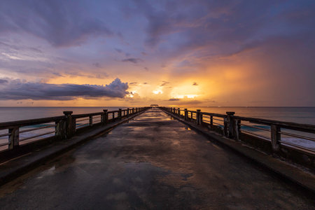 Old bridge pier against beautiful sunset sky after the rain.の写真素材