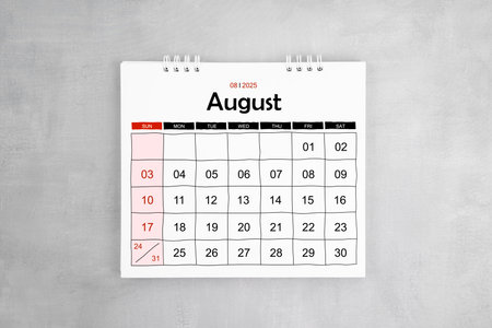 August 2025 desk calendar on gray cement wall background. Page of annual monthly calendar for your plan.の写真素材