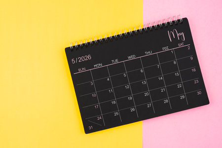 May 2026 Black calendar spiral on yellow and pink color background.の写真素材