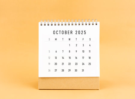 October 2025 desk calendar on yellow color background, Front view.の写真素材