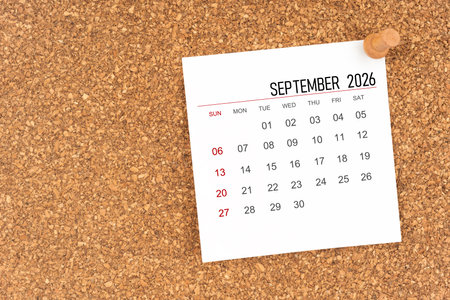 White calendar sheet for September 2026 with thumbtack on wooden board, Position with copy space.の写真素材