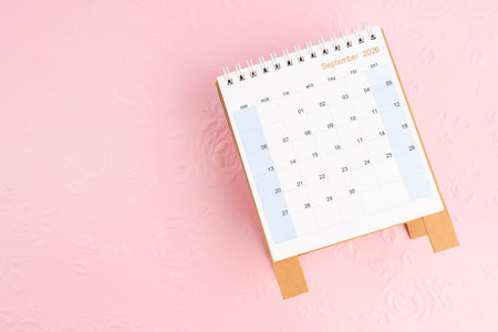September 2026 desk calendar on pink paper with flower pattern background, Flat lay.の写真素材