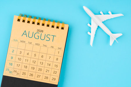 August 2026 calendar and airplane toy on blue color background.の写真素材