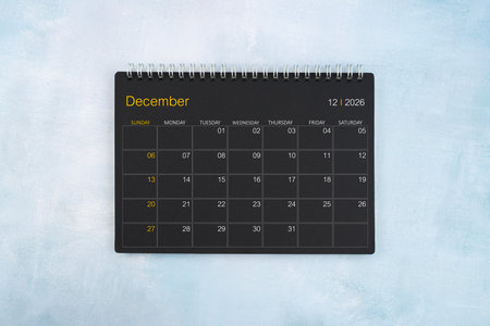 Blank calendar for December 2026, Black spiral desktop calendar on blue wooden background.の写真素材