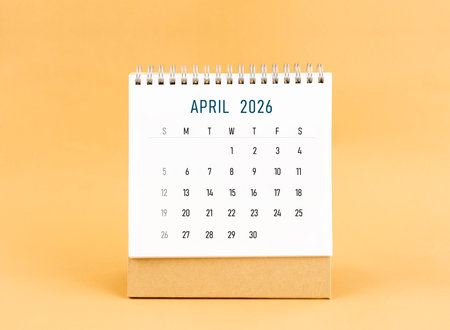 April 2026 desk calendar on yellow color background, Front view.の写真素材