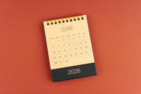June 2026 calendar from brown craft paper on red color background.の写真素材