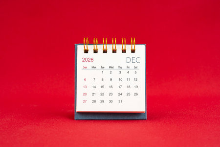 December Mini calendar for 2026 year on red color background.の写真素材