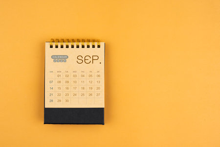 September 2025 calendar from brown craft paper on yellow background.の写真素材