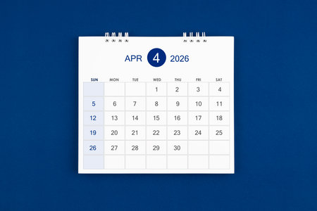 April 2026 Monthly desk calendar on navy blue leather background.の写真素材